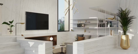 Salon z wykończeniem Dekton Limbo kC na ścianach i schodach, jasna aranżacja z dużym oknem.