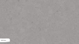 Caesarstone Oyster to elegancki konglomerat kwarcowy w odcieniach beżu i szarości, z charakterystycznymi ciemnymi inkluzjami