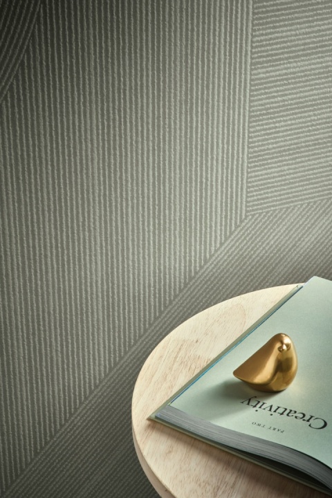 Detal spieku Infinity HL11 Midori 3D, zielono-szara faktura geometryczna przy stoliku z dekoracjami