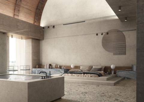 Przestronna aranżacja wnętrza z łóżkiem i ścianami pokrytymi spiekiem Palladium Ivory