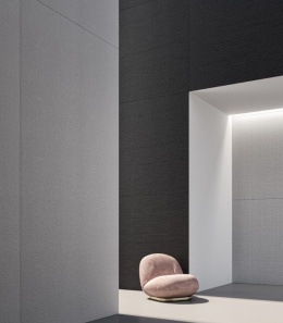 Nowoczesne wnętrze z dużymi płytami Hyle Twill na ścianach w odcieniach bieli, szarości i czerni.