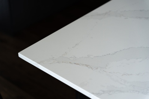 Silestone Et Calacatta Gold to biały spiek kwarcowy z szaro-złotym żyłkowaniem- płyta na czarnym tle.