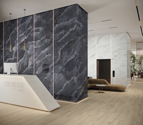 Zestawienie spieków Grespania Alaska Negro i Alaska Ice w eleganckim wnętrzu hotelowym.