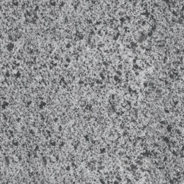 Zbliżenie struktury granitu Grey o jasnoszarej, drobnoziarnistej powierzchni z ciemniejszymi akcentami