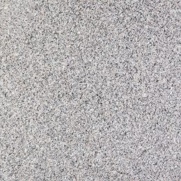 Zbliżenie granitu Rosa Beta o jasnej, drobnoziarnistej strukturze z różowymi i czarnymi wtrąceniami