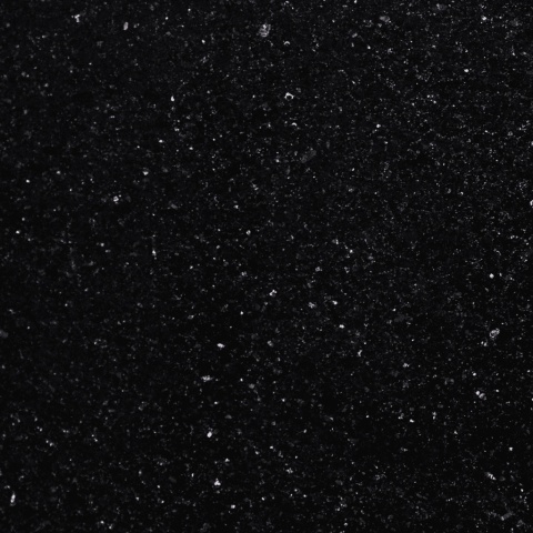 Zbliżenie granitu Star Galaxy o czarnej powierzchni z licznymi złotymi drobinkami