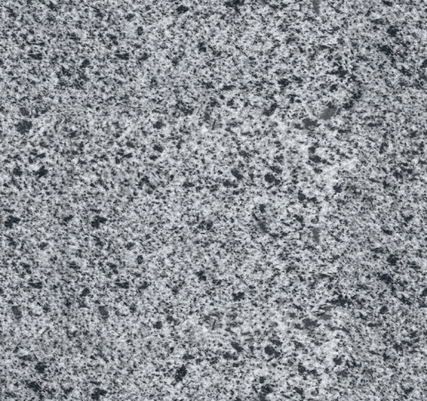 Struktura granitu Grey Płomień w zbliżeniu – naturalna, jasnoszara powierzchnia o wyraźnej chropowatości