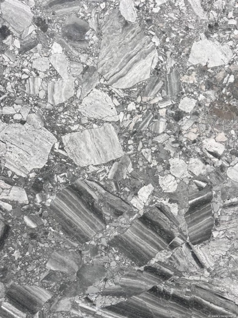 Zbliżenie marmuru Breccia Grigia, kontrastowe szaro-białe fragmenty kamienia tworzące mocny, brekcyjny wzór