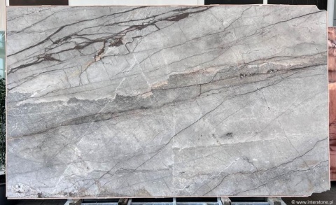 Płyta marmuru Silver River poler, jasnoszare tło z poziomymi ciemnymi żyłami i delikatnym, lustrzanym połyskiem.