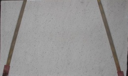 Płyta granitu Perfect White poler, jasna powierzchnia z drobnymi szarymi punktami, widok całej tafli w hali