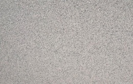 Zbliżenie faktury granitu Rosa Porrino młotek, równomierna chropowata różowo-szara struktura