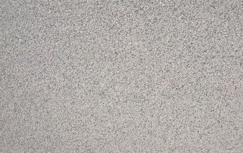 Zbliżenie faktury granitu Rosa Porrino młotek, równomierna chropowata różowo-szara struktura