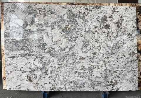 Płyta granitu Siberian White poler, biało-szara tafla z wyrazistym, nieregularnym wzorem, widok całej płyty w hali