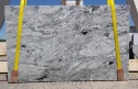 Płyta granitu Viscount White poler – duży slab w jasnoszarym tonie z falującym, ciemnym użyleniem.