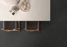 VULCANO Slate - podłoga w granitowym spieku na niej stół z białum blatem i drewniane krzesła