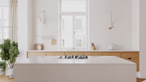 Duża wyspa kuchenna TechniStone Noble Vintage w jasnym wnętrzu z drewnianą zabudową.