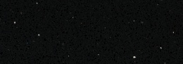 Detal TechniStone Starlight Black z czarną strukturą kwarcową i połyskującymi drobinami.