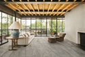Przytulny salon z podłogą ze spieku Silver Root Grey Marazzi, chłodnoszary marmurowy wzór i eleganckie użylenie