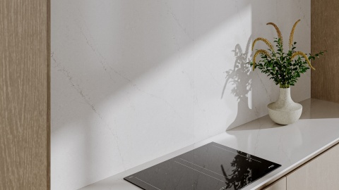 TechniStone Mistral White na blacie kuchennym i ścianie z delikatnym, jasnoszarym użyleniem.